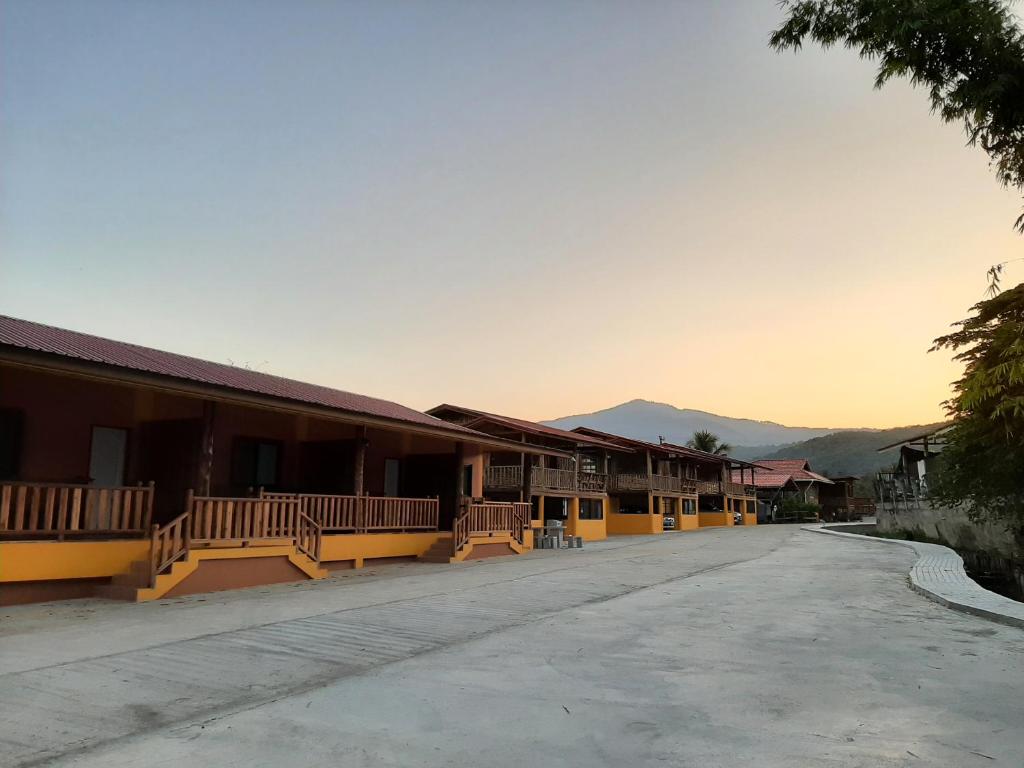 an empty street in a town with buildings at Baan Berm Family Inn 