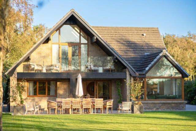 a house with a table and chairs in front of it at 6 Bed in Ainsdale oc-w33455 in Ainsdale