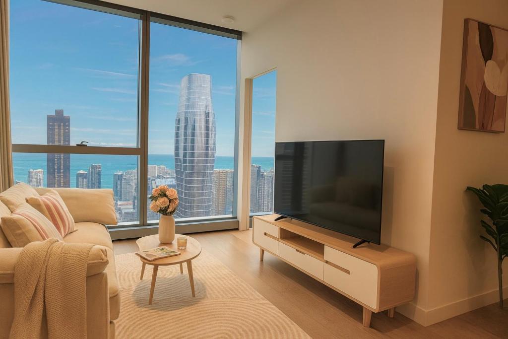 a living room with a television and a large window at Luxury High-Rise Ocean View Perfect Stay at WSP in Melbourne