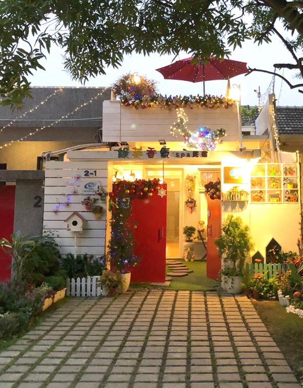 a house decorated for christmas with a red door at Green Fu Spa Homestay in Kaohsiung