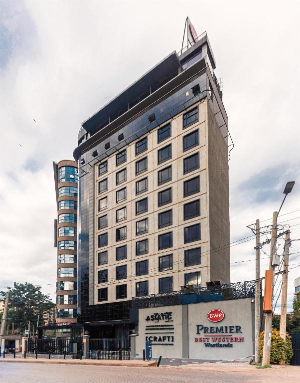 a large white building with a sign in front of it at Best Western Premier Westlands in Nairobi