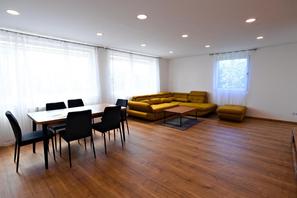 a room with a table and chairs and a couch at Ferienwohnung Zirbitzblick in Fohnsdorf