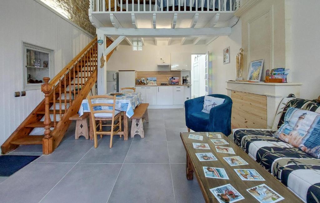 a living room with a couch and a table at 1 Bedroom Cozy Home In La-Gripperie-Saint-Sym in La-Gripperie-Saint-Symphorien