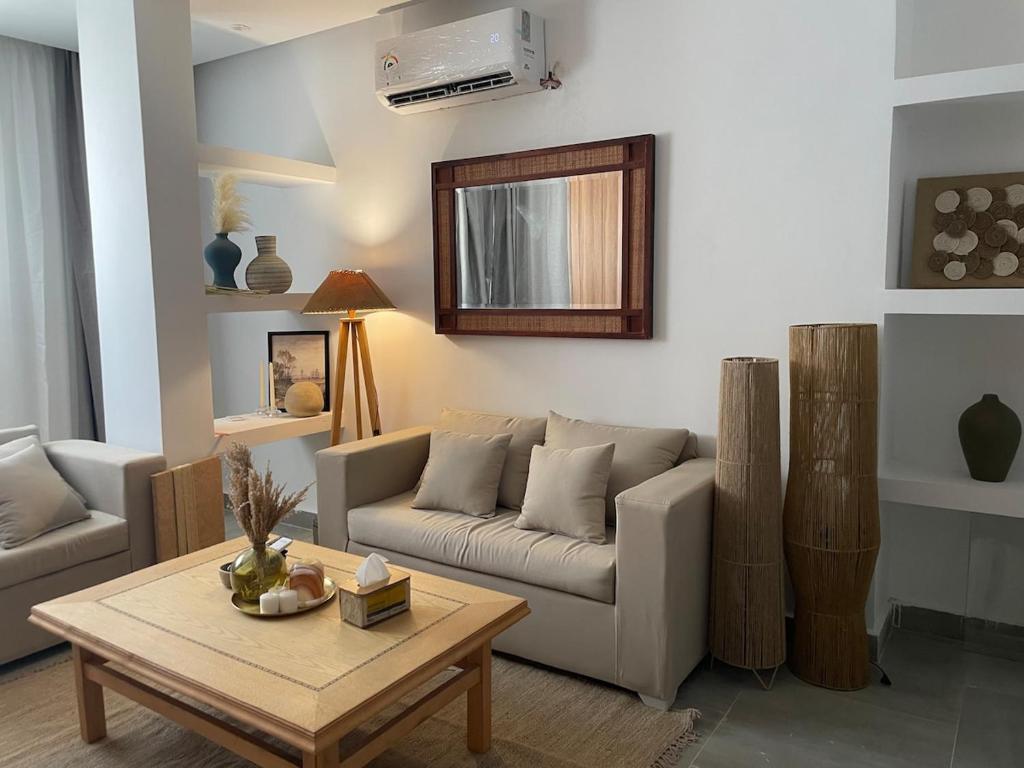 a living room with a couch and a table at Modern Boho Chalet in Central Sharm El Sheikh in Sharm El Sheikh