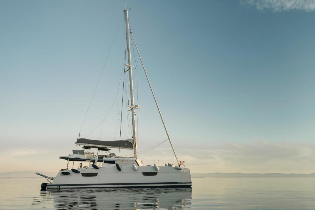 a white boat sitting in the middle of the water at Dione Catamaran in Thessaloniki