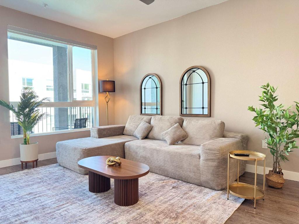 a living room with a couch and a table at Upscale Escape 10 Min from Disneyland With Pool & Gym in Tustin