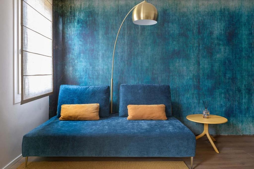 a blue couch sitting in a room with a table at Casa Abelia - Boutique Apartment in Venice