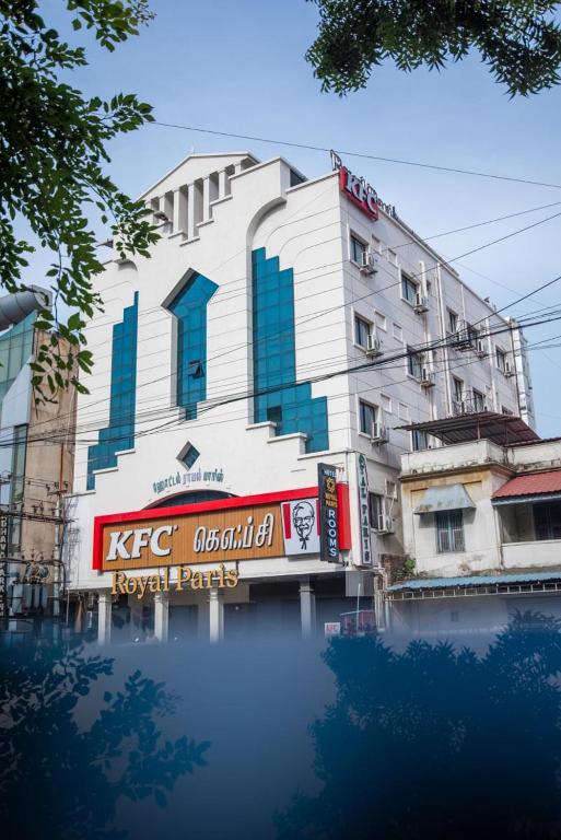 a building with a reflection in a body of water at Royal Paris in Chennai