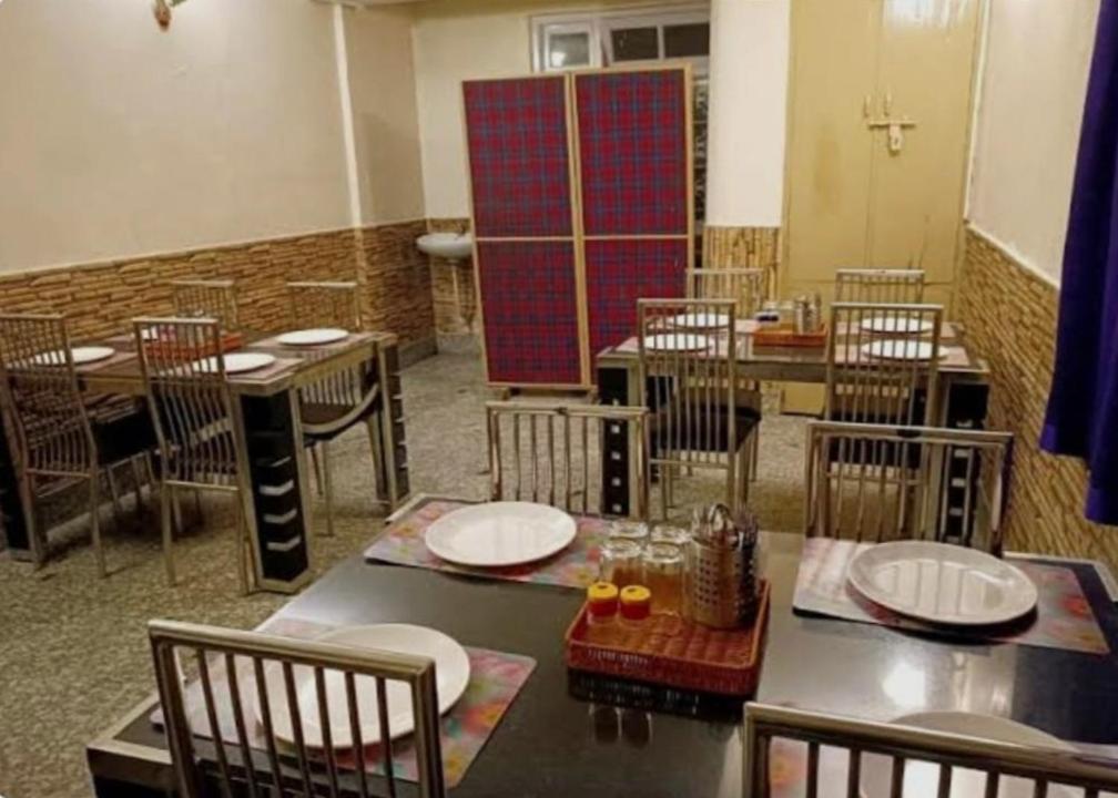 a dining room with tables and chairs and a table and chairsktop at SnowCap Regency in Gangtok