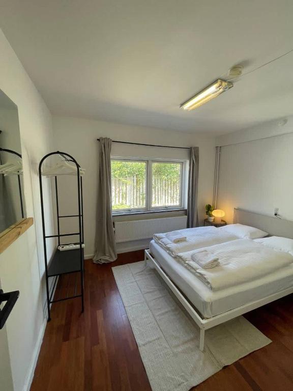 a bedroom with a large bed and a window at Spacious Private House in Amager in Copenhagen
