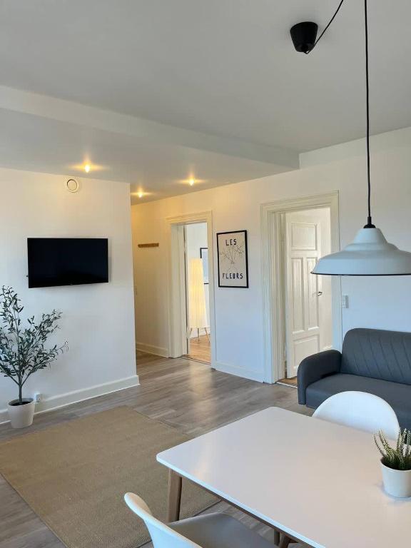 a living room with a couch and a table at Stunning 6-Pax Valby in Copenhagen