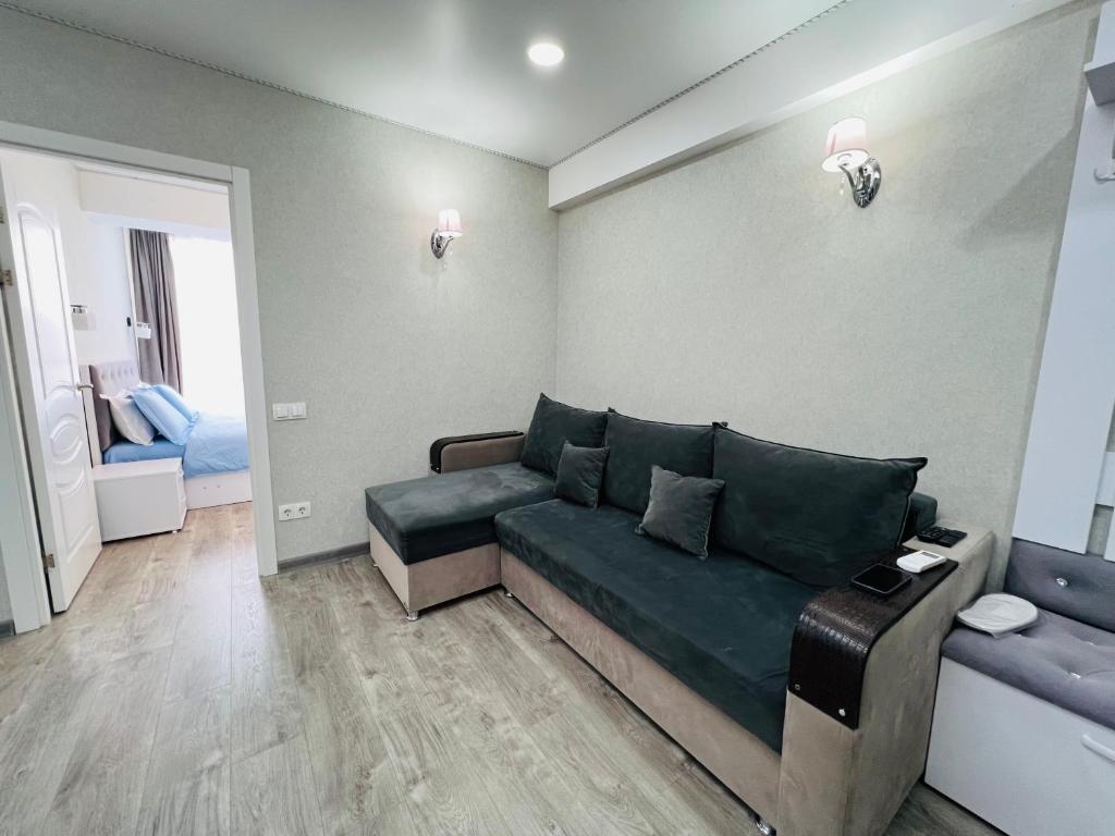 a living room with a couch in a room at Malldova Chișinău centru in Chişinău