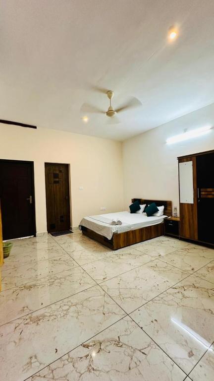 a bedroom with a bed and a ceiling at Rams Guest House Meadows Walk to Varkala Papnasam Beach - Groups & Couple friendly in Varkala