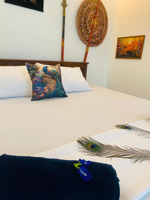 a pair of beds with a blue ribbon on them at MB Villa in Beruwala