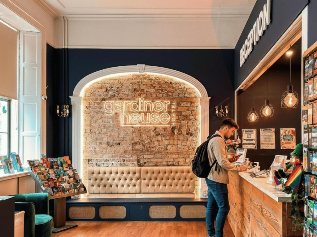 a man standing at a counter in a store at Gardiner House Hostel in Dublin