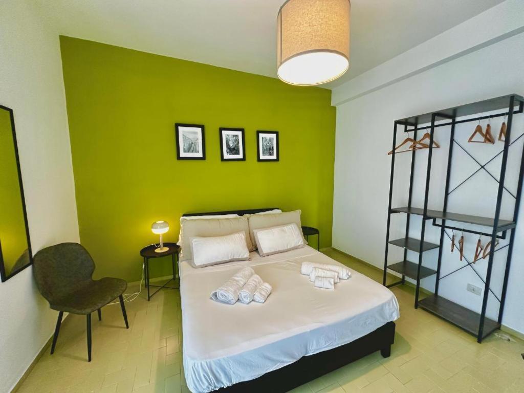 a bedroom with a bed with a green wall at ROOF and SKY SUITE 5 FLOOR in SORRENTO CENTER in Sorrento