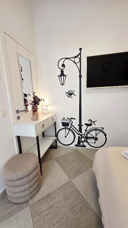 a bedroom with a desk and a bike next to a lamp at FREE parking Marli 4 - Room with private entrance - in Dubrovnik