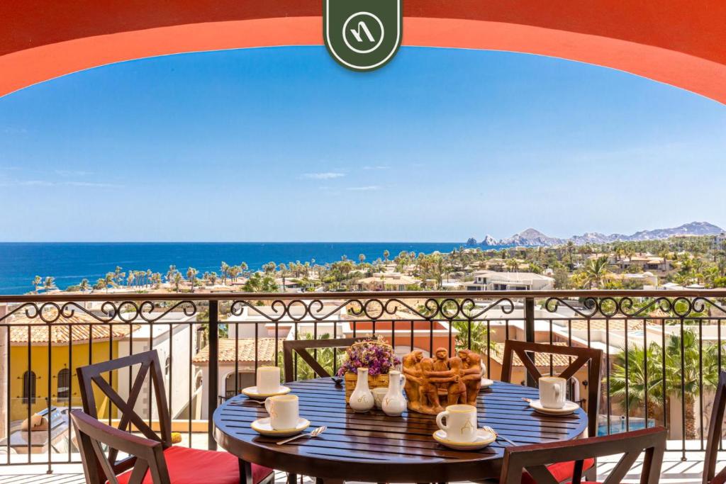 a table on a balcony with a view of the ocean at Amazing House with Private Terrace - Private Pool in El Tule