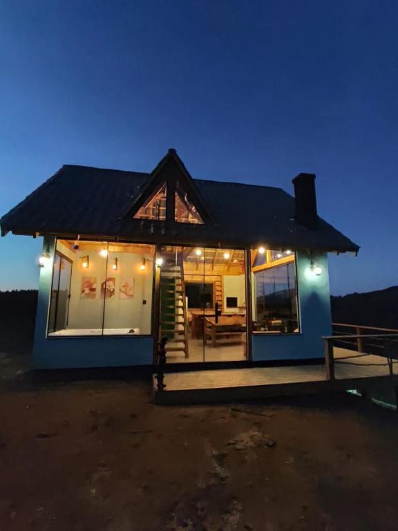 a small house with lights on it at night at Cabana com Hydro, Recanto das Trutas, SC in Bocaina do Sul