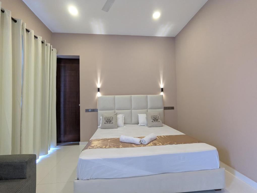 a bedroom with a large white bed in a room at Maariyo Hotel and Restaurant in Panadura
