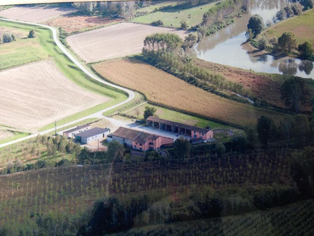 an aerial view of a house on a hill next to a river at Agriturismo Cascina Mezzulli in Ostiano