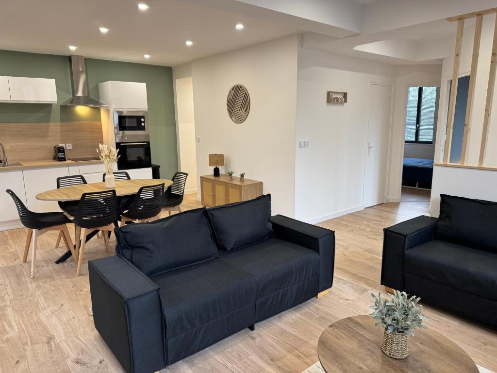 a living room with a couch and a table at Family Apparts Criel in Criel-sur-Mer
