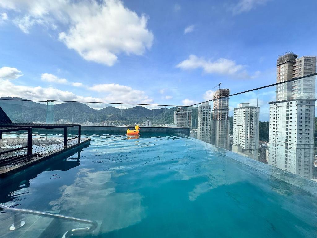 a swimming pool on the roof of a building at Studio with pool, pool table, gym and sauna in Itapema