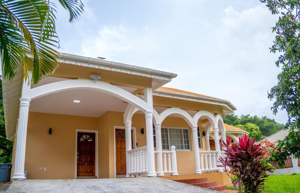 a house with an archway in front of it at Villa del Nique in Pembroke