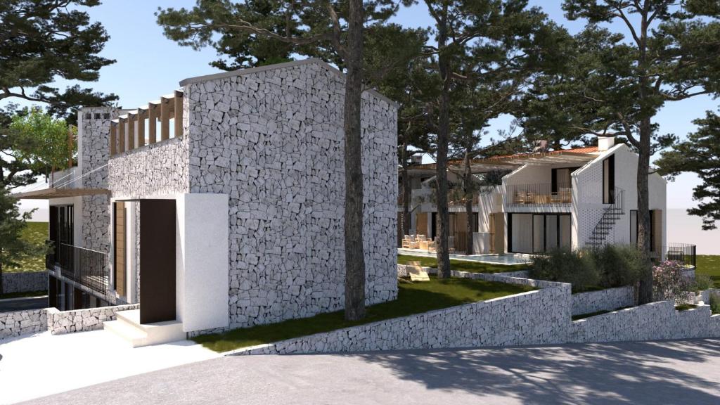 a house with a stone wall and trees at VICE VERSA -Seaside boutique Villa with Pool in Punat