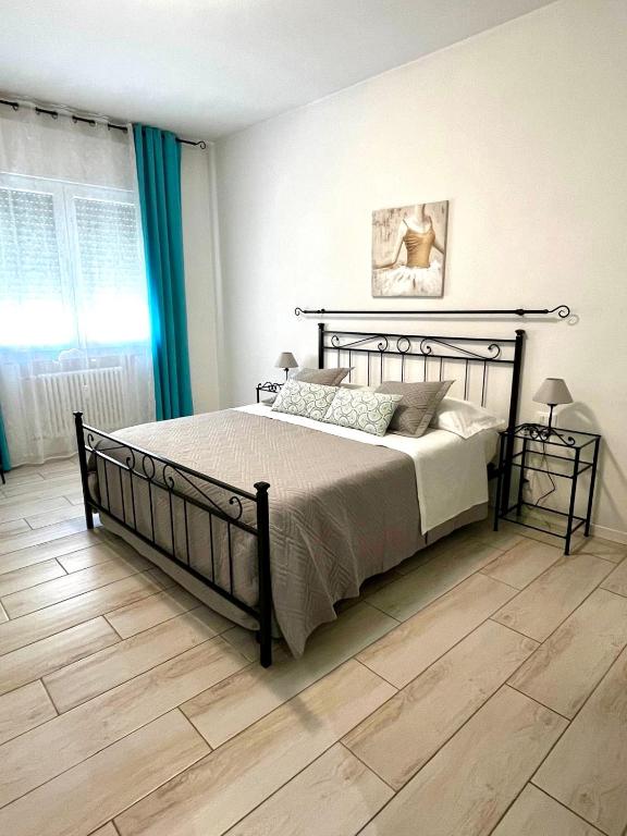 a bedroom with a bed and a wooden floor at Yaya's House - Venice in Mestre