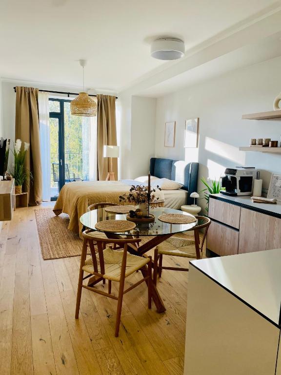 a living room with a table and a couch at MuunLiving in Ķesterciems