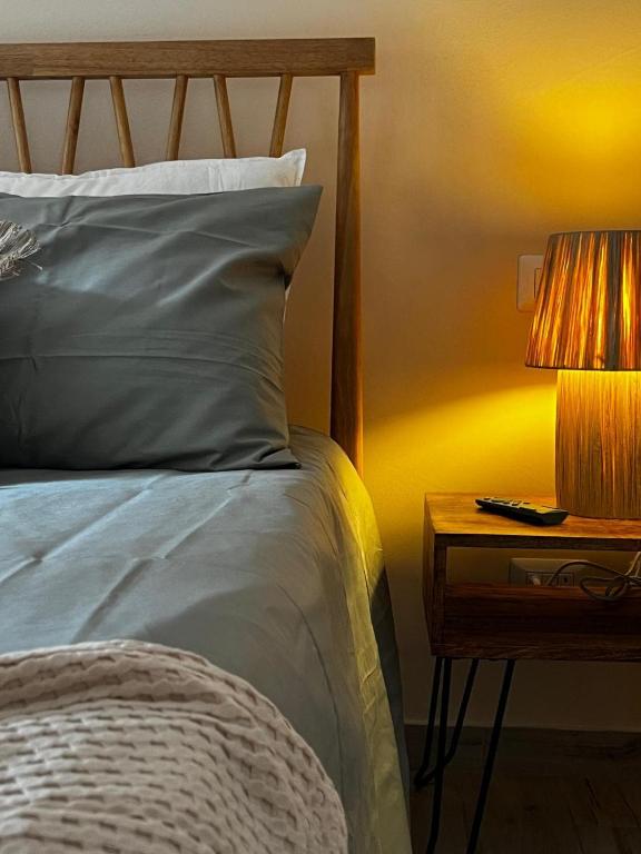 a bed with a lamp on a nightstand next to a bed at Tropical Cocoon in Monza in Monza