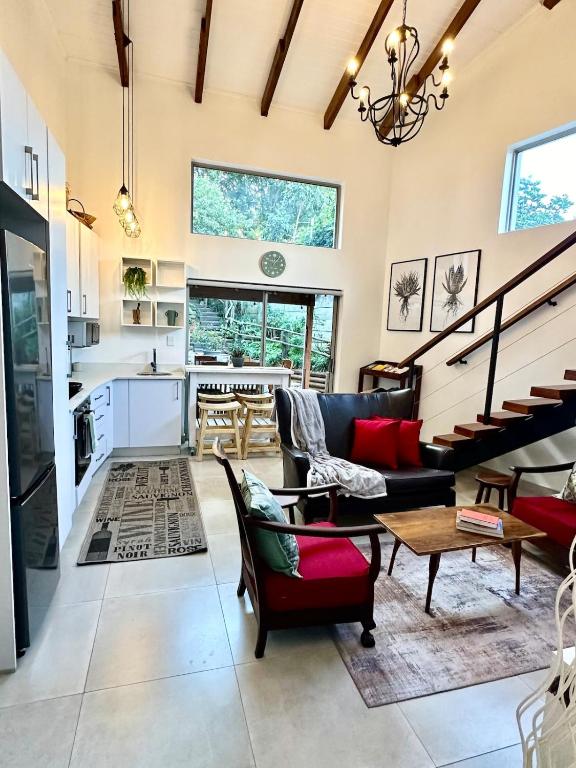 a living room with a couch and a table at ONE on Michelle in Ballito