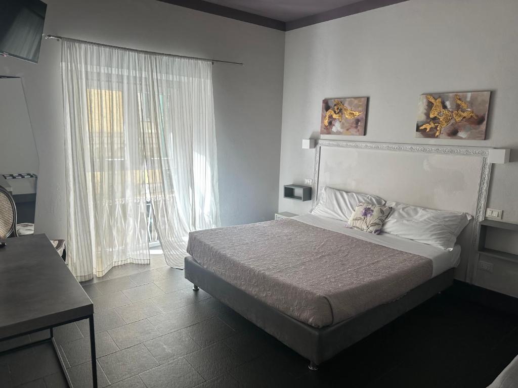 Ένα ή περισσότερα κρεβάτια σε δωμάτιο στο Holidays Rooms Rattazzi