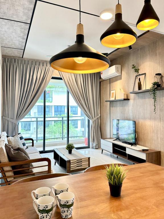 a living room with a wooden table and a large window at Starview Bay 3pax Forest City in Gelang Patah