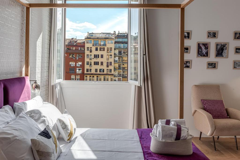 a bedroom with a bed and a large window at Marmo - Sweet Dreams in Florence in Florence