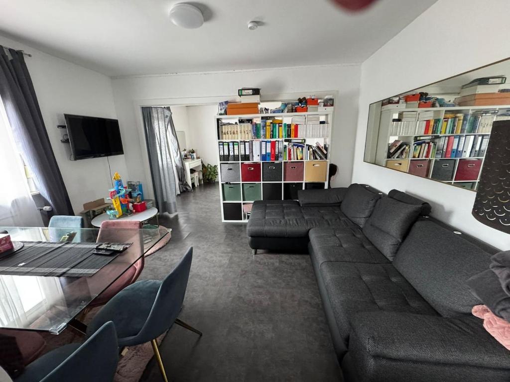 a living room with a couch and a table at Ferienwohnung mit Terrasse in Hofheim am Taunus