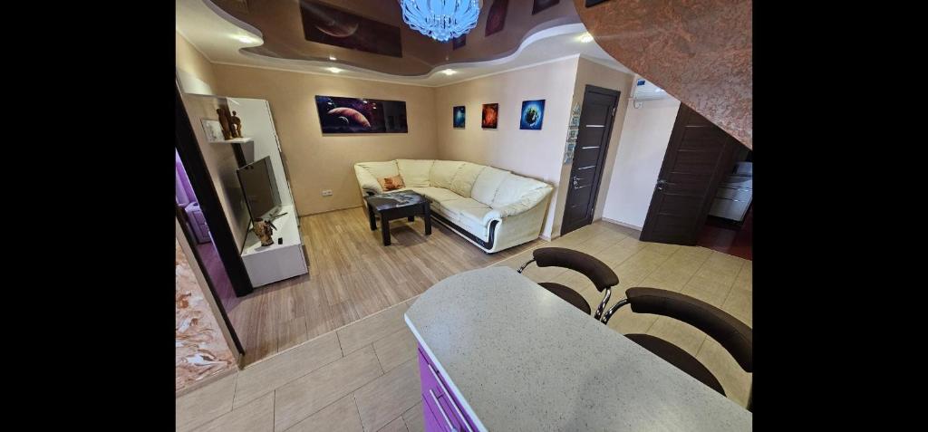 a living room with a couch and a table at Penthouse 15 floor in Kamianske