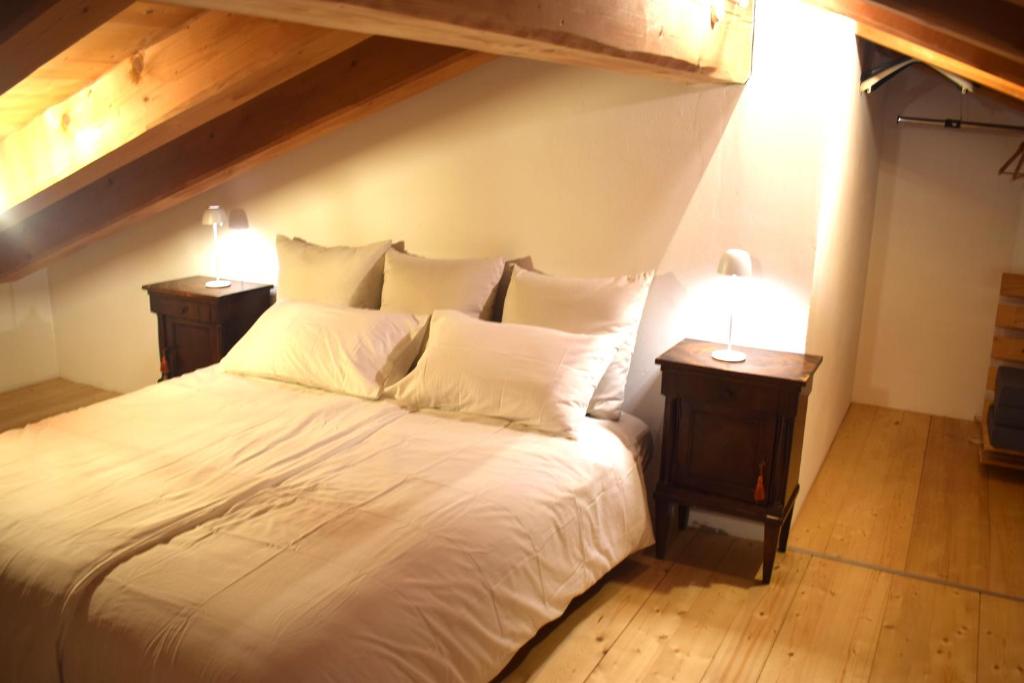 a bedroom with a white bed with two night stands at Casa ALMA 