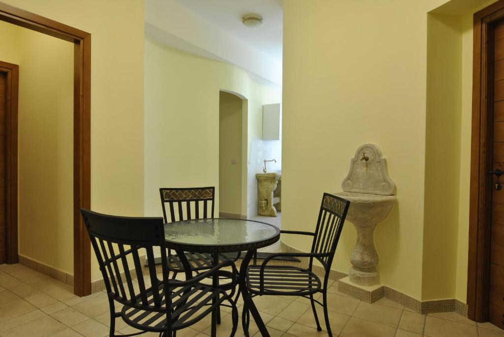 uma sala de jantar com uma mesa e duas cadeiras em Roma Tourist House em Roma