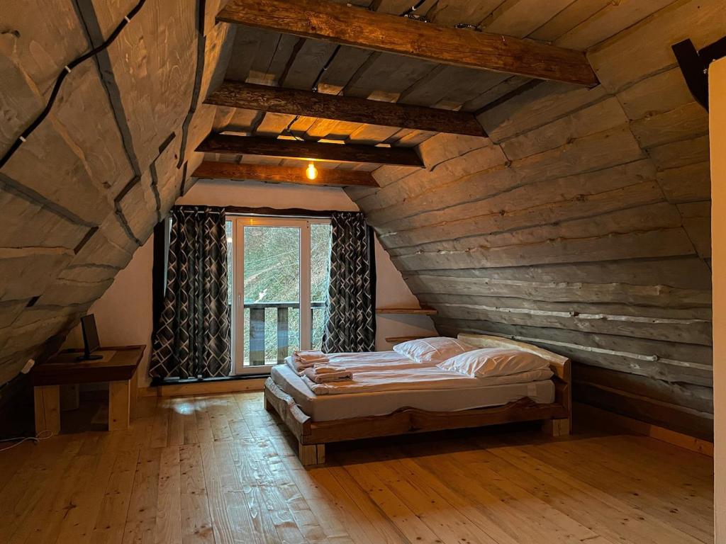 a bedroom with a bed in an attic at Pustirnik in Rakhiv
