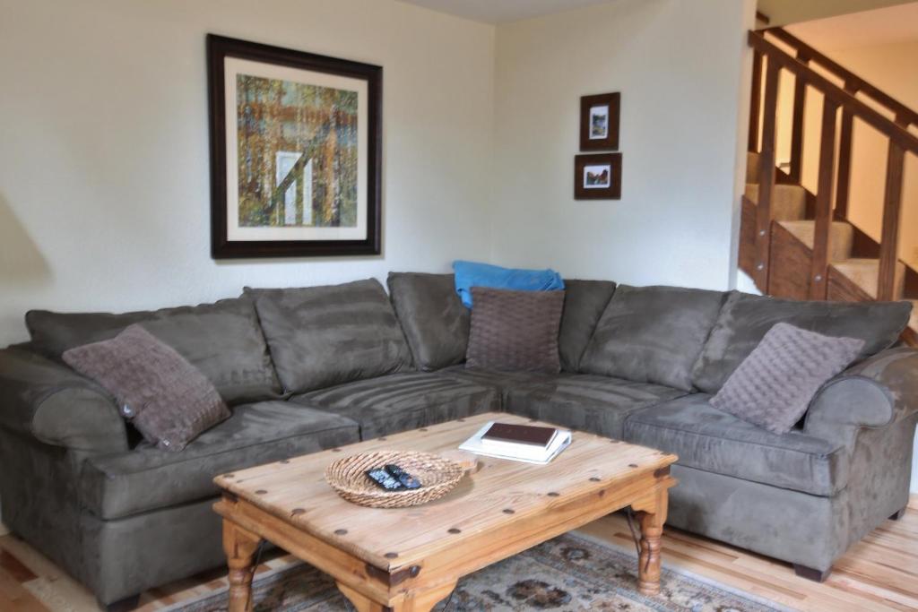 a living room with a couch and a coffee table at Pet Friendly 8 Leisure Home in Sunriver