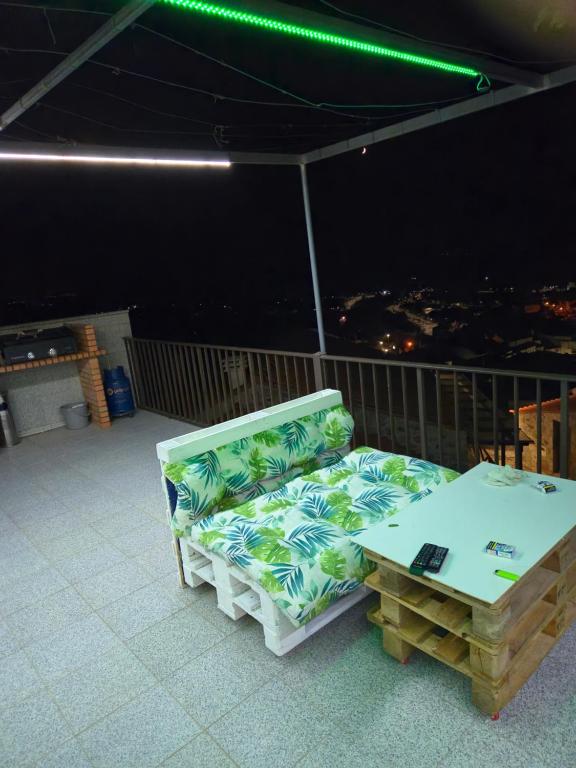 a couch and a table on a balcony at Casa do castelo in Penamacor