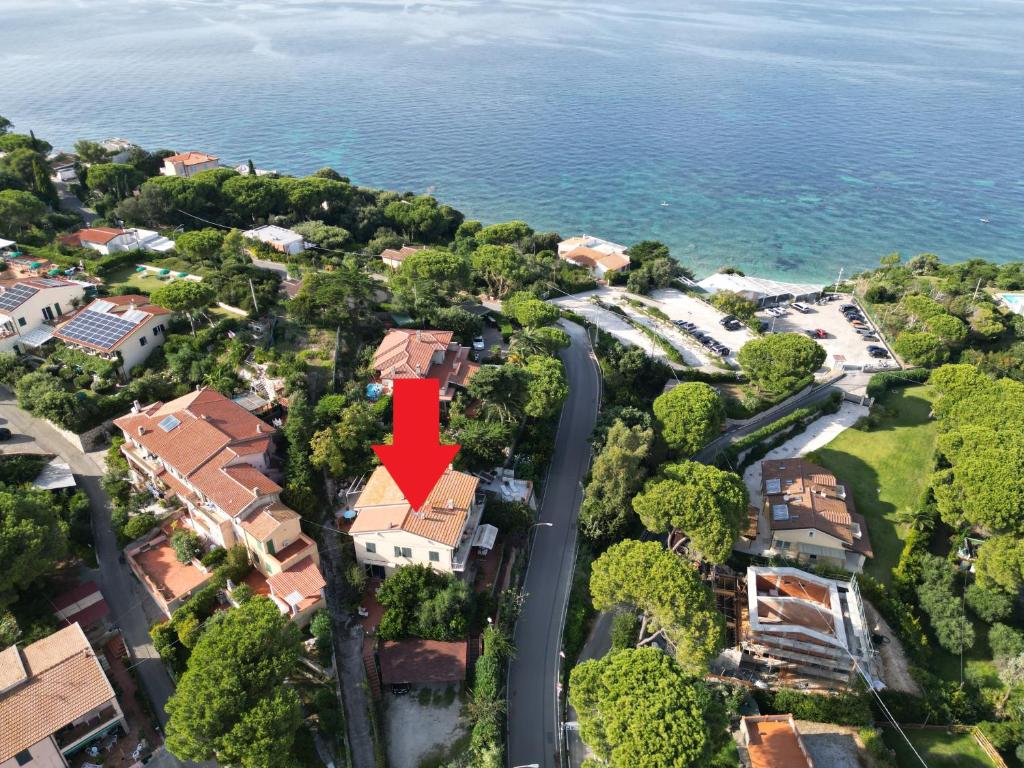 a house with a red arrow on top of it at Capo Bianco Terrace - Helloelba in Portoferraio
