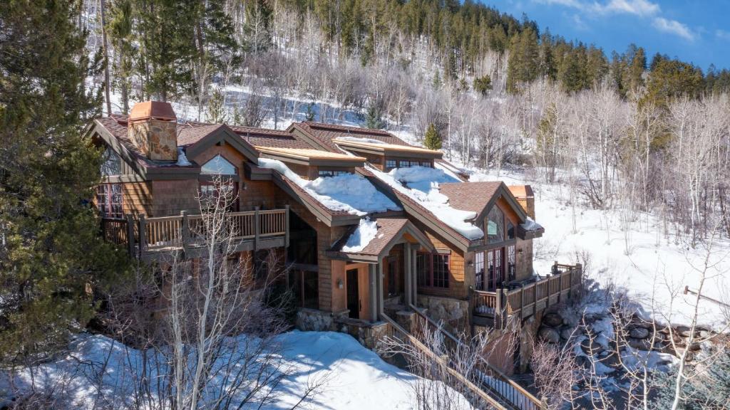 a log home in the snow in the woods at Vail View by AvantStay Minutes from Beaver Creek in Dowds Junction