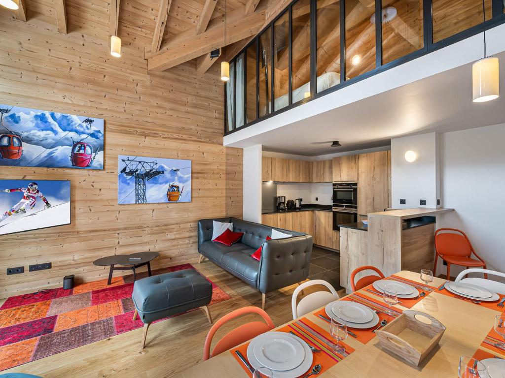 a living room with wooden walls and tables and a couch at Duplex de Charme à Courchevel Moriond, à Proximité des Pistes et Commodités - FR-1-563-57 in Courchevel