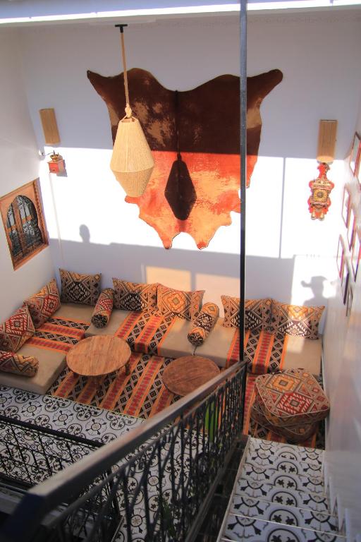 a room with couches and tables on a staircase at Dar Skouri 51 in Marrakesh
