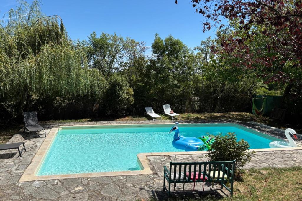 a swimming pool with a swan in a yard at 2 Bedroom Cottage - Sleeps 6 - Pool - Garden in Caylus
