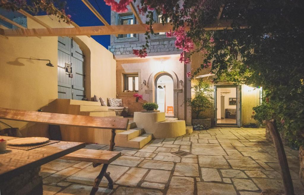 an outdoor patio with a bench and a table at Villa Allegra in Kythira