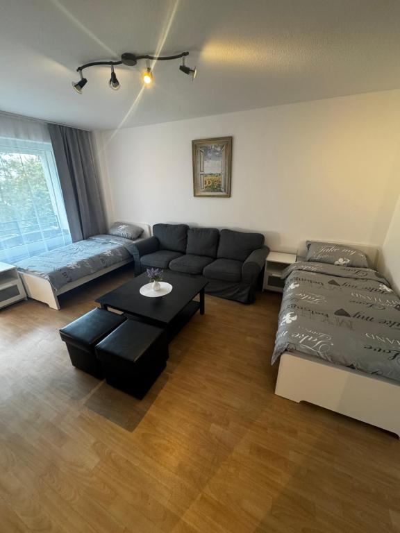 a living room with a couch and a coffee table at Moderne Monteurwohnung in der Nähe vom VW Werk 1 in Wolfsburg